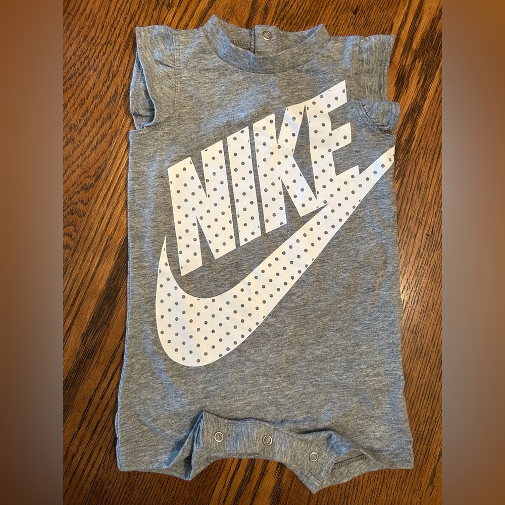 Nike Gray Romper with White Logo. 6 months. Snaps at back neck & crotch. Girl.